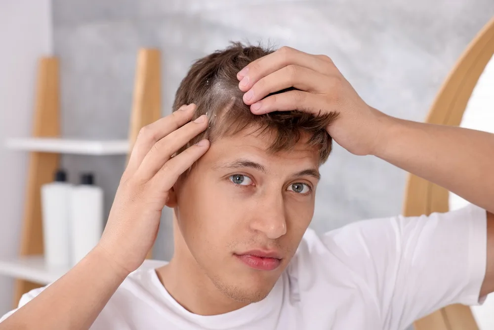 Man losing hair booking an appointment to visit a Trichologist near Manchester